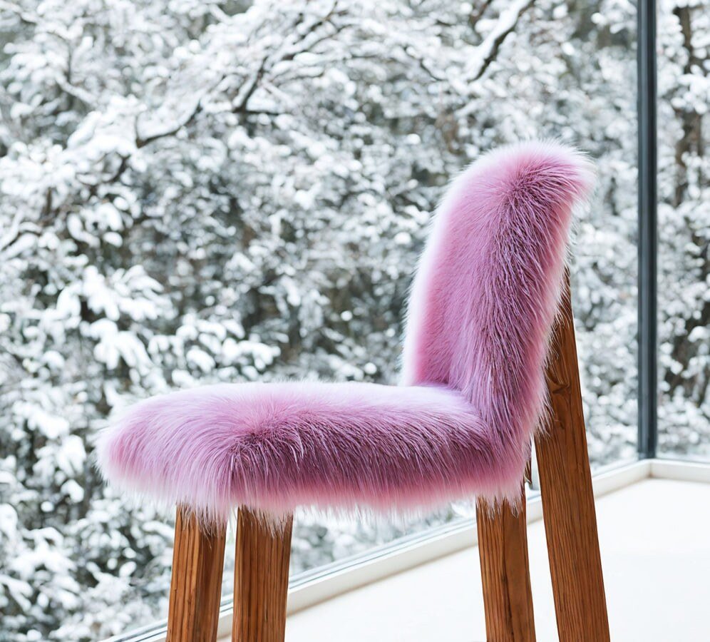 A chair rendered with a pink fur finish, in a snowy setting